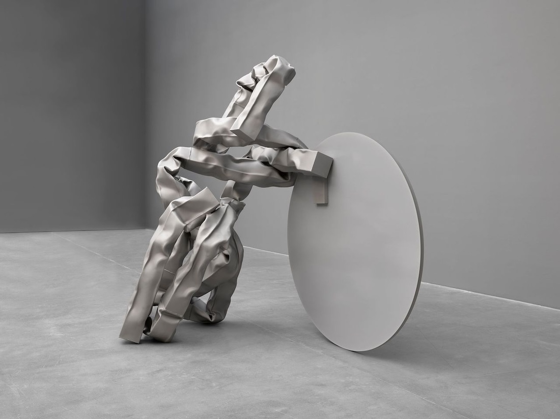 Carol Bove, Vase Face I / The Ascent to Heaven on a Dentist’s Chair , 2022. Stainless steel and laminated glass with heat - fused ink, 85 × 87 × 57 1/2 in. (215.9 × 221 × 146.1 cm). Collection of the artist. © Carol Bove Studio LLC. Photo: Maris Hutchinson